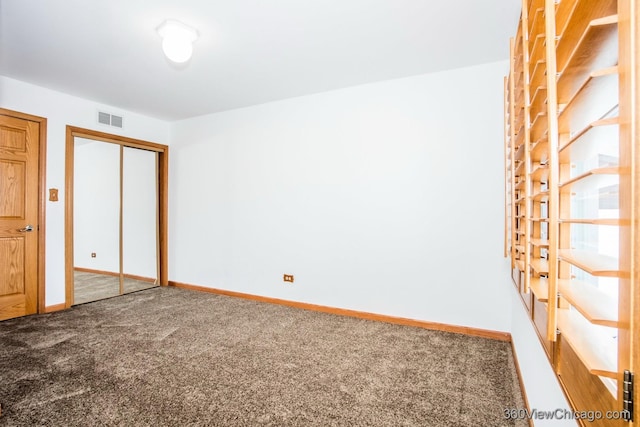 unfurnished bedroom with carpet flooring and a closet