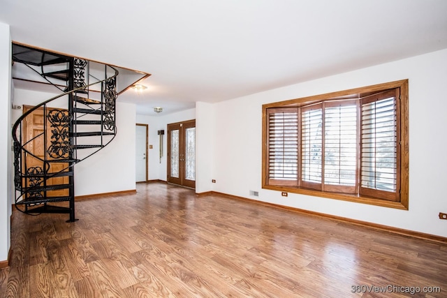 unfurnished living room featuring wood-type flooring