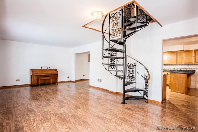 stairs featuring hardwood / wood-style flooring