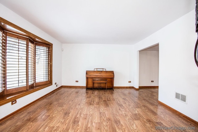 spare room with hardwood / wood-style flooring