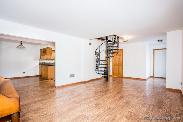 unfurnished living room with light hardwood / wood-style flooring