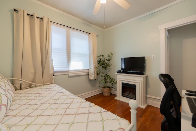 bedroom with a baseboard heating unit, crown molding, ceiling fan, and dark wood-type flooring