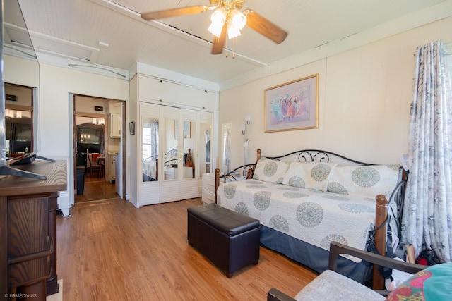 bedroom with ceiling fan, wood-type flooring, french doors, and a closet