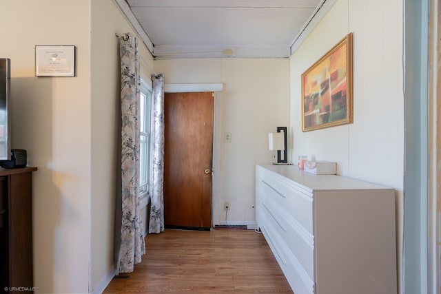 hall with light hardwood / wood-style flooring and crown molding