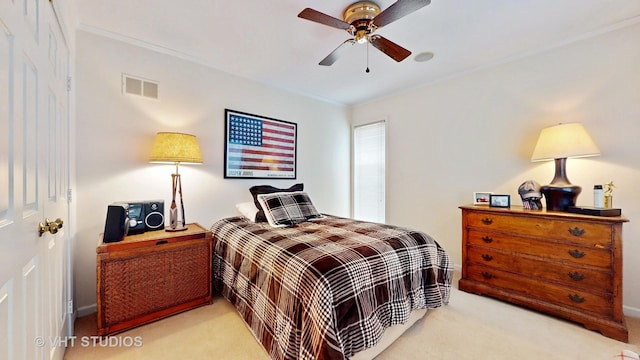 bedroom featuring visible vents, a ceiling fan, carpet flooring, and crown molding