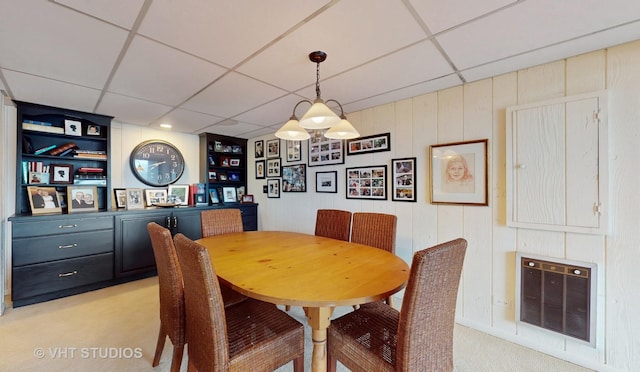 dining space featuring a paneled ceiling and light colored carpet