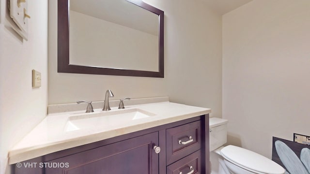 bathroom with toilet and vanity