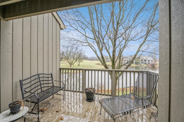 wooden terrace featuring a water view