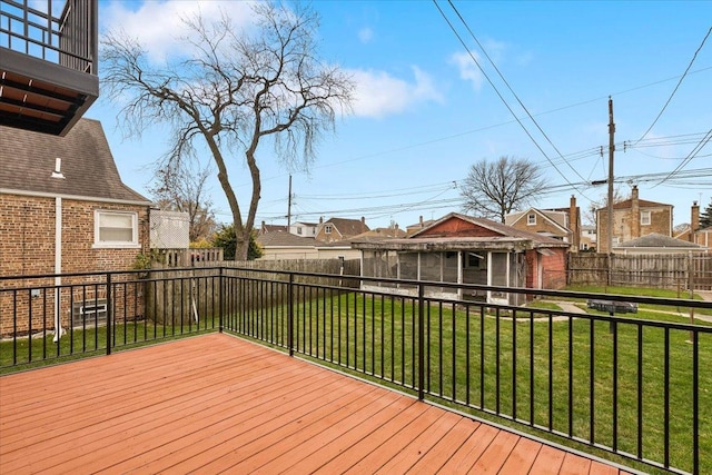 wooden deck featuring a lawn