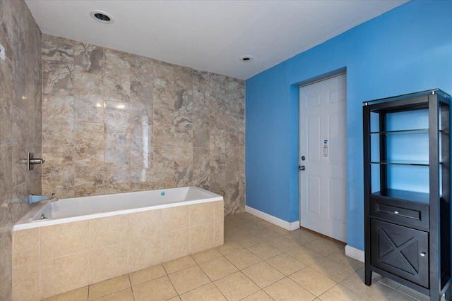 bathroom featuring tile patterned floors and tiled tub