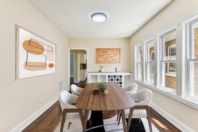 dining space with hardwood / wood-style floors and a healthy amount of sunlight