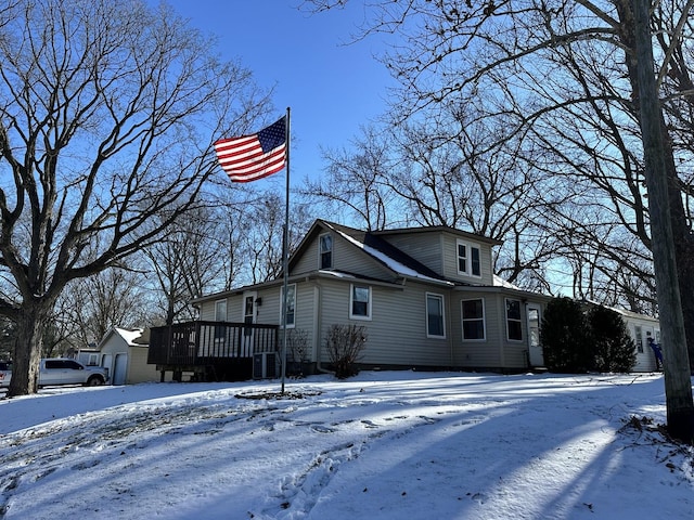 view of snow covered exterior featuring a wooden deck and central AC unit