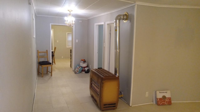 hallway with an inviting chandelier and ornamental molding