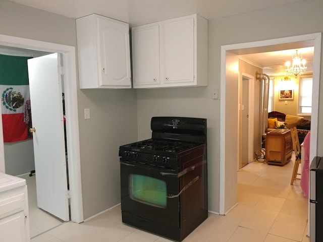 kitchen with ornamental molding, a notable chandelier, black gas range, white cabinetry, and light tile patterned flooring