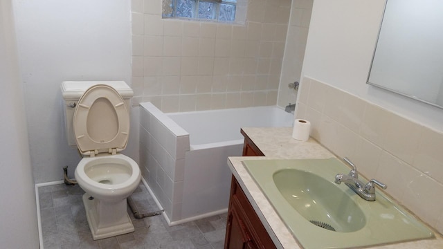 bathroom with vanity, a bathtub, tile patterned floors, and toilet