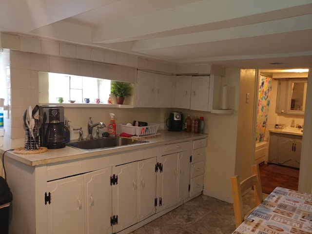 kitchen with white cabinetry and sink