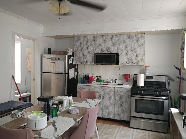 kitchen featuring backsplash, ornamental molding, and appliances with stainless steel finishes