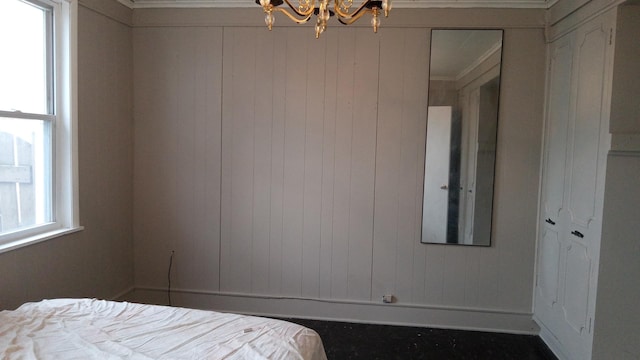 unfurnished bedroom featuring a chandelier