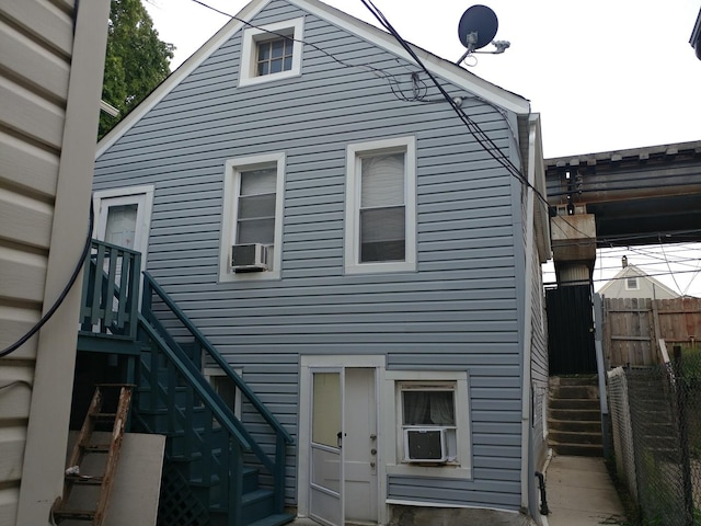 rear view of property with cooling unit