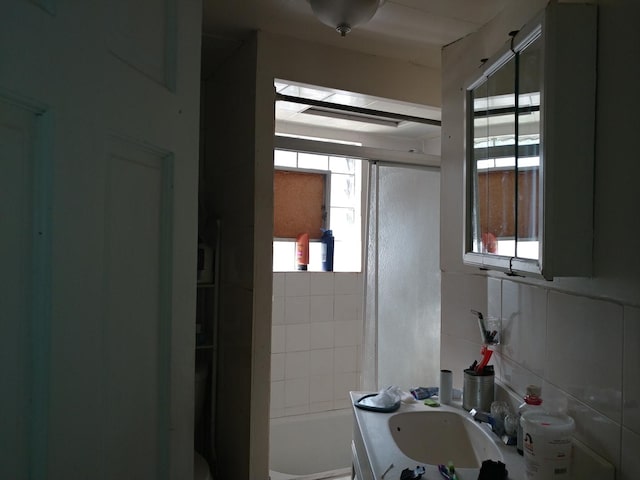 bathroom with tiled shower / bath combo and vanity