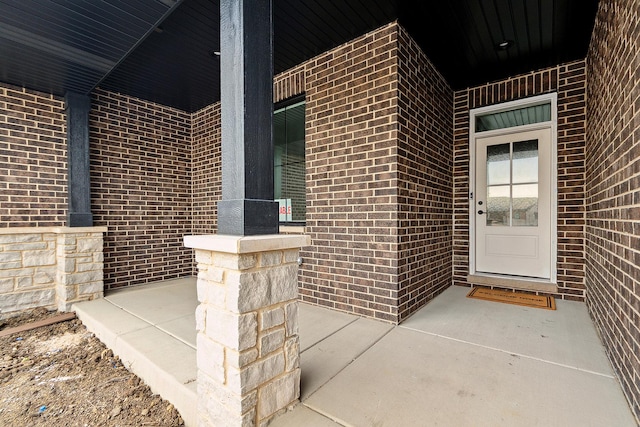 property entrance with brick siding