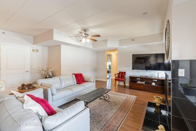 living room with ceiling fan and hardwood / wood-style floors