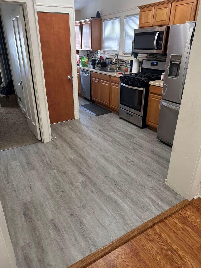 kitchen with sink, light hardwood / wood-style flooring, and appliances with stainless steel finishes