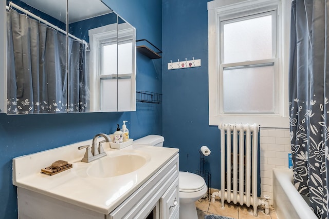 full bathroom featuring shower / bath combo, tile patterned floors, radiator, vanity, and toilet