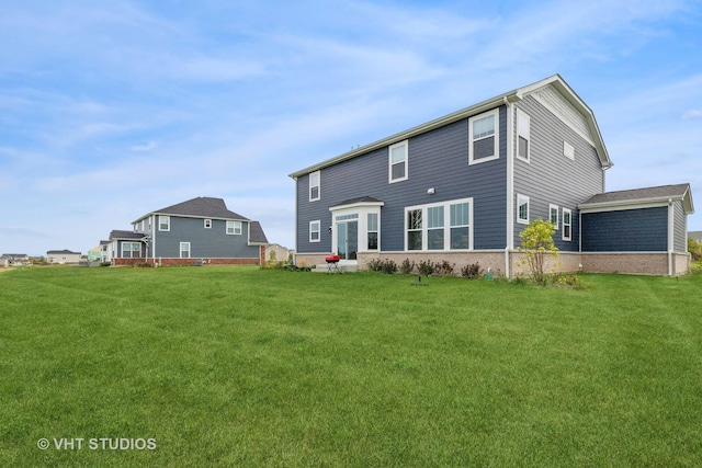 rear view of property featuring a yard