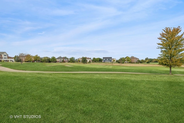 view of home's community with a yard