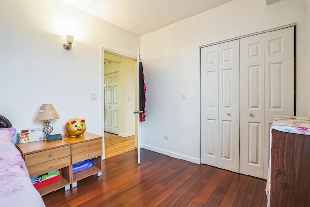 bedroom featuring dark hardwood / wood-style floors and a closet