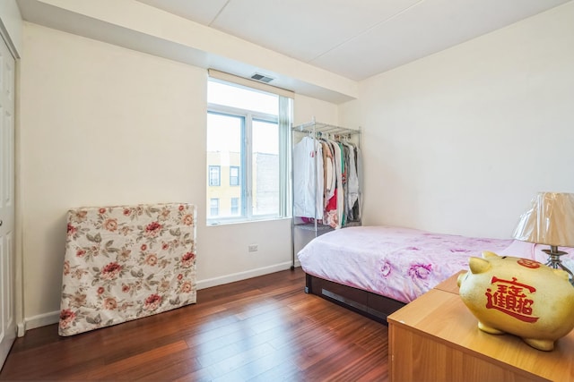 bedroom with dark hardwood / wood-style floors