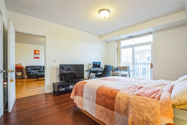 bedroom featuring access to outside and dark hardwood / wood-style flooring