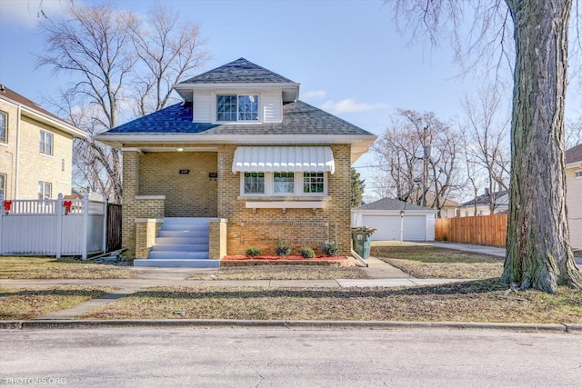 view of front of house featuring a garage and an outdoor structure