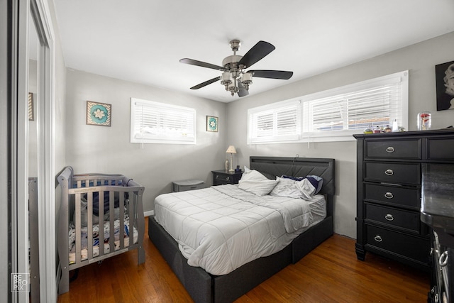 bedroom featuring ceiling fan and dark hardwood / wood-style flooring