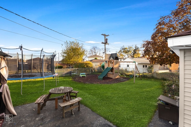 view of yard with a playground and a trampoline