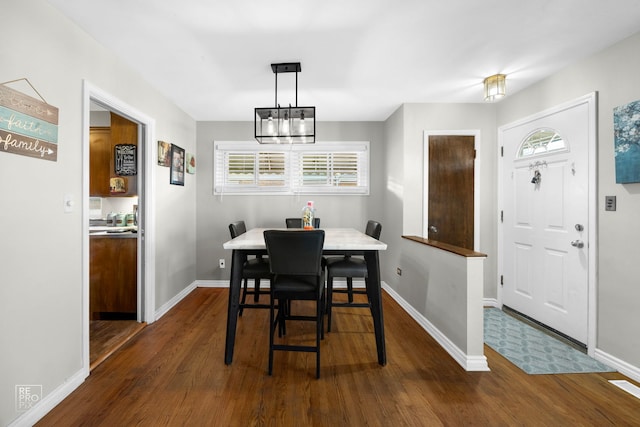 dining room with a wealth of natural light, a chandelier, and dark hardwood / wood-style floors