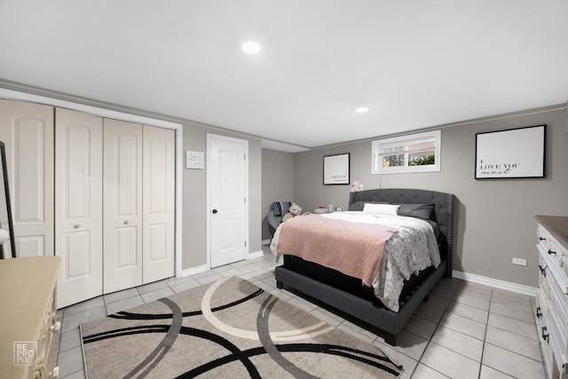 bedroom with a closet and light tile patterned flooring