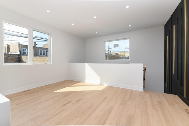 unfurnished room with light wood-type flooring