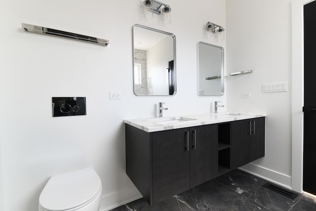 bathroom featuring vanity and toilet