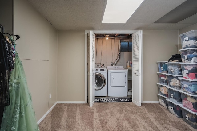 clothes washing area with carpet flooring and independent washer and dryer