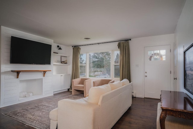 living room featuring dark hardwood / wood-style flooring and a baseboard heating unit