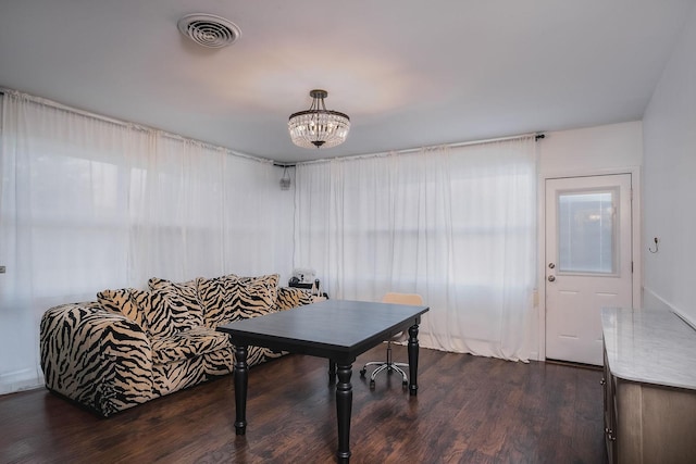 office space featuring dark hardwood / wood-style flooring and a notable chandelier