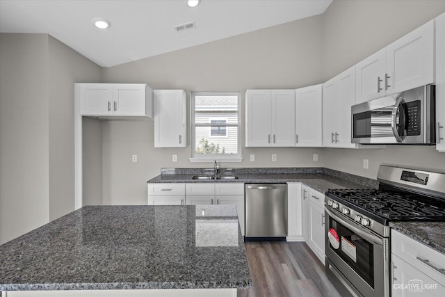 kitchen with a center island, sink, white cabinets, and stainless steel appliances