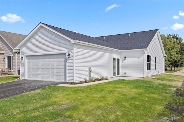 exterior space with a garage and a front lawn