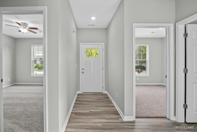 interior space with light colored carpet and ceiling fan