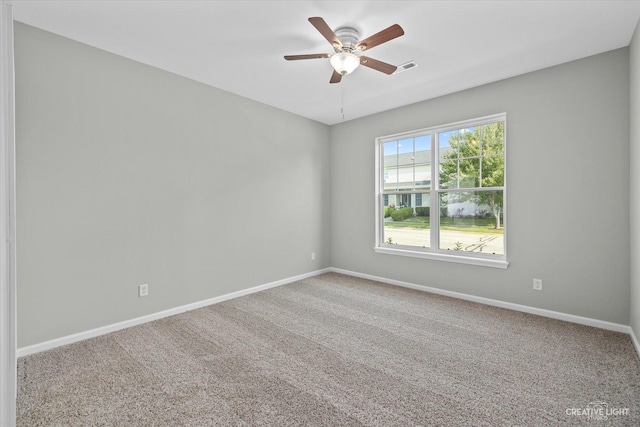 carpeted spare room with ceiling fan