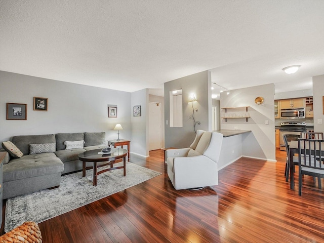 living room with hardwood / wood-style floors, rail lighting, and a textured ceiling