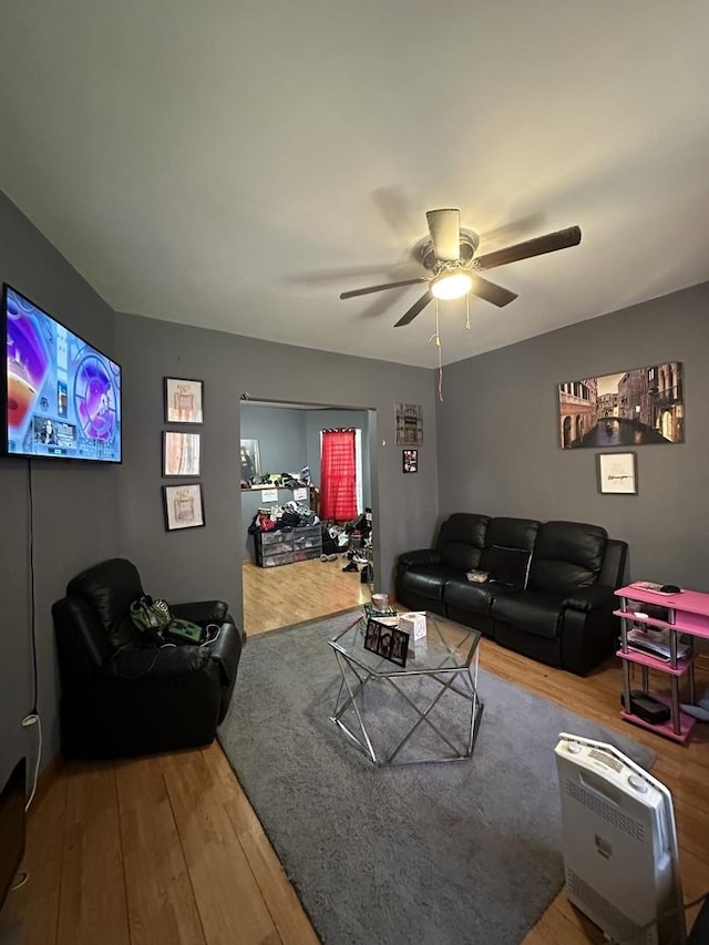 living room with ceiling fan and hardwood / wood-style flooring