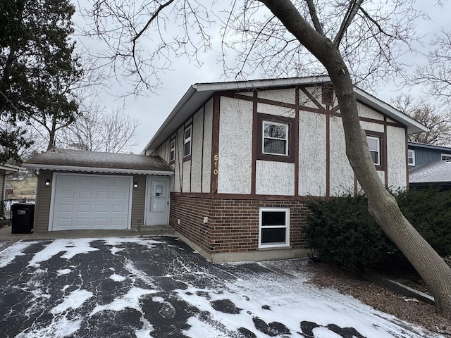 view of snow covered exterior featuring a garage